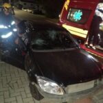 Carro colide em veículo, bate em poste e capota